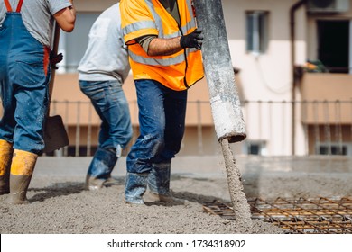 Construction Details - Worker Laying And Pouring Cement Or Concrete With Automatic Pump
