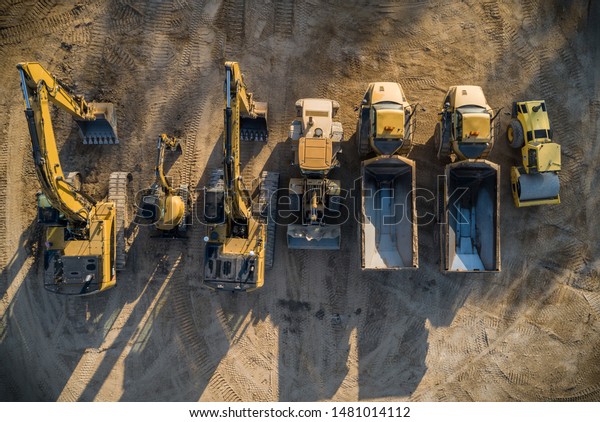 Construction dirt moving equipment lined up for\
the night.
