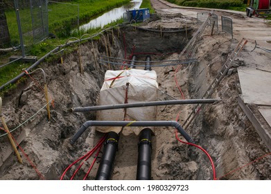 Construction Of A District Heating System For Eco Friendly Homes.
The Sustainable Heat Pipes For Eco Friendly Houses In The Netherlands Are Photographed At A Low Angle With Nature In The Background.