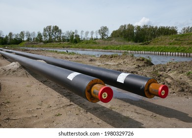 Construction Of A District Heating System For Eco Friendly Homes.
The Sustainable Heat Pipes For Eco Friendly Houses In The Netherlands Are Photographed At A Low Angle With Nature In The Background.