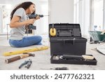 Construction, drill and wall with DIY woman in home for decoration, maintenance or repairs. Design, power tools and project management with person in apartment for building, improvement or remodel