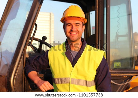 Construction driver with excavator on the background
