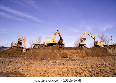 Construction Earthworks Excavator Grader Machine Loading Earth Into Large Truck Vehicles