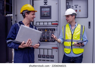 Construction electrician engineer caucasian man working with laptop in concept of good management electrical system for construction, logistic, import export transportation business in workplace area. - Shutterstock ID 2206046021