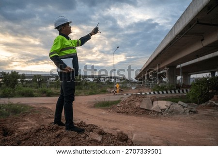 Construction engineer overseeing infrastructure development urban site photography outdoor candid perspective project management