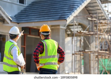 Construction engineer talks to the architect on the construction site. To describe home design work - Powered by Shutterstock