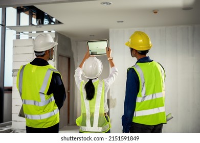 Construction Engineer team uses tablets to take photo and record data while inspecting construction work,  Checking to light on ceiling and other systems above ceiling