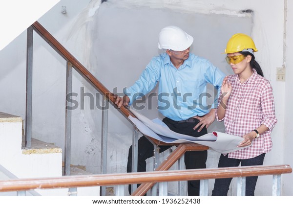 Construction engineer teamwork Safety Suit Trust\
Team Holding White Yellow Safety hard hat Security Equipment on\
Construction Site. Hardhat Protect Head for Civil Construction\
Engineer Concept