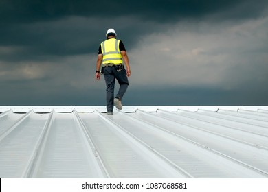 Construction engineer wear safety uniform inspection metal roofing work for roof industrial concept with copy space