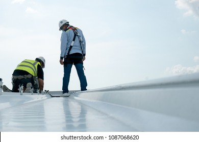 Construction engineer wear safety uniform inspection metal roofing work for roof industrial concept with copy space - Shutterstock ID 1087068620