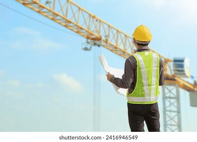 construction engineer worker in protective helmet and blueprints paper on hand at building site background