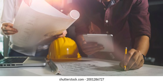Construction engineer working at blueprint to build large commercial buildings in office. Engineering tools and construction concept. - Shutterstock ID 2001286727