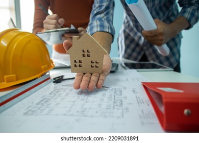 Construction Engineer Working At Blueprint To Build Large Commercial Buildings At Home