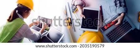 Construction engineer working at blueprint to build large commercial buildings in office. Engineering tools and construction concept.