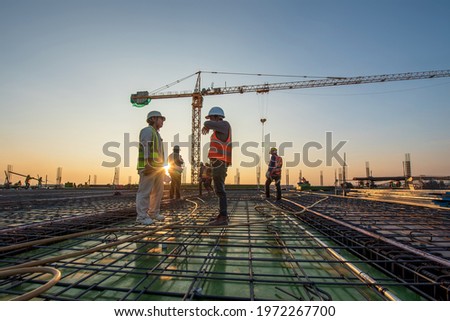 Construction engineer working at construction site during sunset time