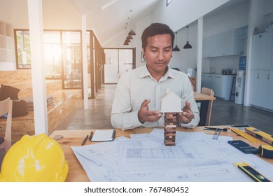 Construction engineering. Architect drawing blueprints and engineering tools on workplace