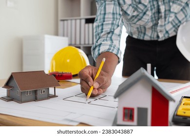 Construction engineers are checking blueprints and calculating their accuracy after receiving plans from architect in order start  construction safely. Inspection Concept from construction engineering