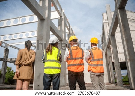 construction engineers and the client are discussing project plans over the phone on site.