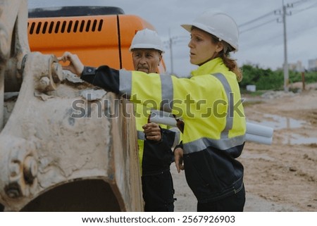 Construction engineers are discussing and using machinery and macros for large-scale construction projects.