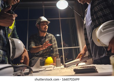 Construction engineers discussion with architects at the meeting room with Blueprint Architecture on Desk, Working overtime, Compulsory overtime. - Shutterstock ID 1660702699