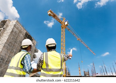 Construction engineers discussion with architects at construction site or building site of highrise building - Shutterstock ID 622211642