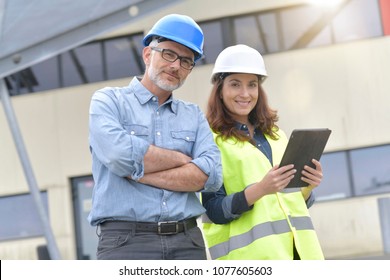 Construction Engineers Meeting Outside Building