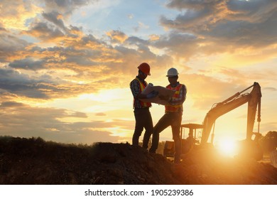 Construction engineers supervising progress of construction project ,Engineering Consulting People on construction site holding blueprint in his hand.  - Shutterstock ID 1905239386