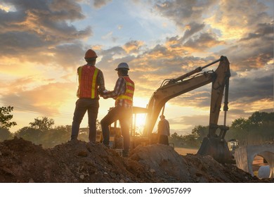 Construction engineers supervising progress of construction project stand on new factory,Engineering Consulting People on construction site holding blueprint in his hand. Building inspector.  - Shutterstock ID 1969057699
