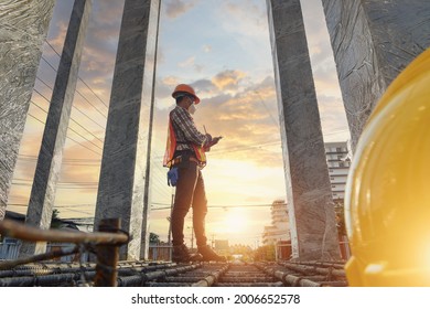 Construction engineers supervising progress of construction project stand on new factory,Engineering Consulting People on construction site holding blueprint in his hand.  - Shutterstock ID 2006652578