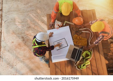 Construction engineers supervising progress of construction project stand on new factory,Engineering Consulting People on construction site holding blueprint in his hand. Building inspector. Construct - Shutterstock ID 2016175949