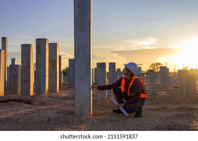 Construction engineers survey checkpoints of concrete pile,  load-bearing piles of the tall building at the construction site evening time. - Shutterstock ID 2151591837