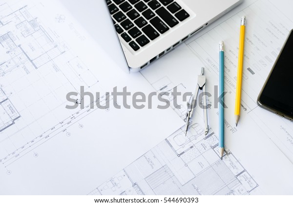 Construction equipment. Repair\
work. Drawings for building Architectural project, blueprint rolls\
and divider compass on table. Engineering tools concept. Copy\
space.
