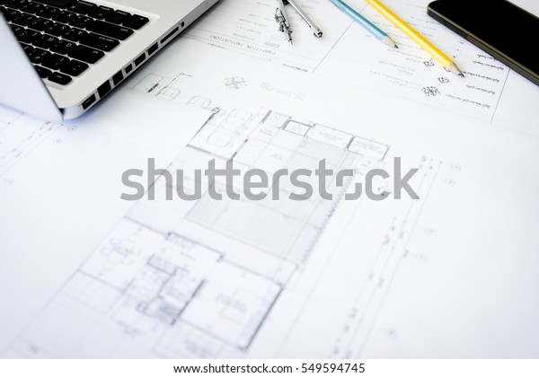 Construction equipment. Repair
work. Drawings for building Architectural project, blueprint rolls
and divider compass on table. Engineering tools concept. Copy
space.