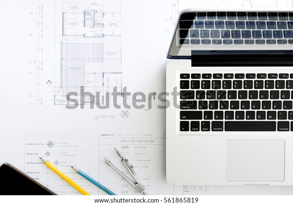 Construction equipment. Repair\
work. Drawings for building Architectural project, blueprint rolls\
and divider compass on table. Engineering tools concept. Copy\
space.