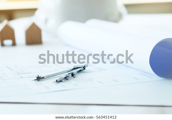 Construction equipment. Repair work. Drawings
for building Architectural project, blueprint rolls and divider
compass on table. Engineering tools and copy space of Architecture
and Engineer
Desktop..