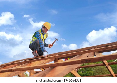 Construction Expertise Male Roofer Carpenter Wear Safety Uniform Working On Roofs Structure On Construction Site