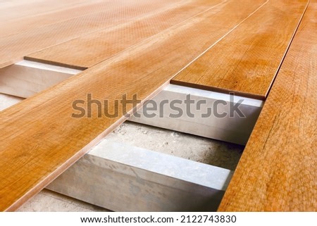 Construction floor installation wooden work flooring wood plank. Timber flooring installation deck board. Repair floor covering. Repair house deck floor renovation home. Timber decking wood floorboard