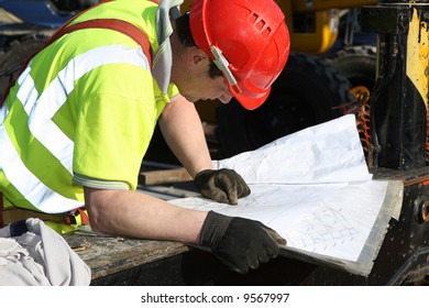 Construction foreman checking drawings - Powered by Shutterstock