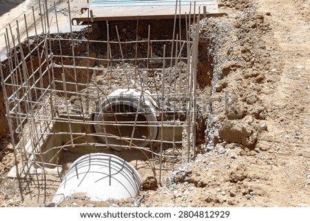 Construction of a foundation for laying cement drainage pipes.