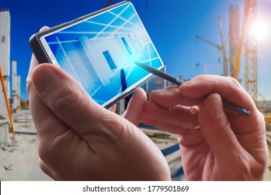 Construction future technology. Smartphone in hands of builder. High-tech construction. Using modern building technologies. Construction technology for phone. Application for designing a smartphone