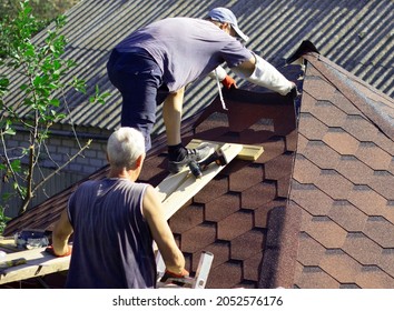 Construction Of A Gazebo, A Specialist In Roofing. Laying Tiles On The Roof