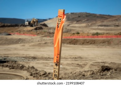Construction grading stake with construction equipment in background - Shutterstock ID 2199108407
