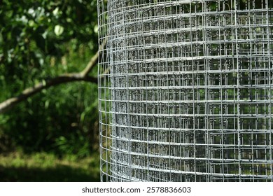 Construction grid with a square cell for formwork, frame or fence. Building grid for various ideas and designs in the garden. Roll of mesh wire made of steel, close-up.