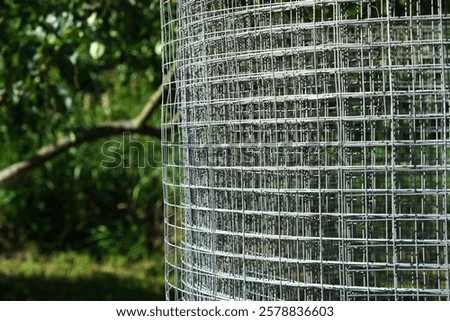 Construction grid with a square cell for formwork, frame or fence. Building grid for various ideas and designs in the garden. Roll of mesh wire made of steel, close-up.