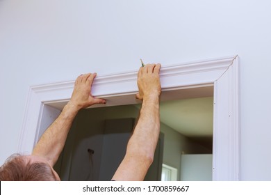 Construction handyman is working on renovation of apartment of door molding - Powered by Shutterstock