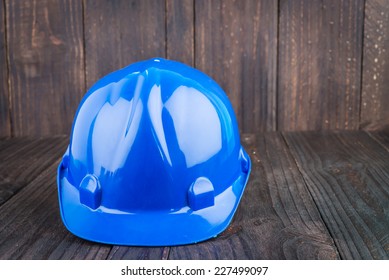 Construction Hard Hat On Wooden Background