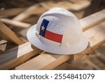 Construction Hat With Texas Flag Sticker on Planks of Wood at Construction 