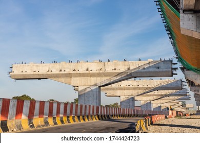 Construction Of Highway Overpass Bridge And Rail Transit Infrastructure In Progress With Morning Sun Rays In Malaysia