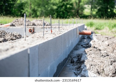 construction of house foundations - foundation strips with reinforcements and sewerage preparation, new house construction, rough construction
