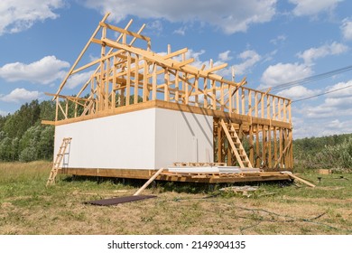 Construction Of A House Outside The City. The Frame Of The House On Stilts. The Concept Of Life In The Village. There Are Fields And Woods Around.